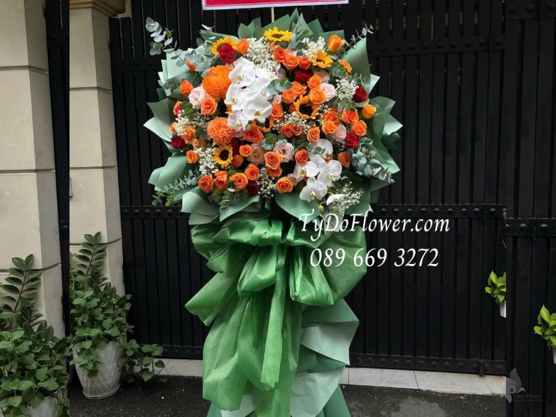 KCM0825621 KỆ HOA CHÚC MỪNG SINH NHẬT Thiết kế gam màu cam, hoa hồng cam sprit, cúc mẫu đơn cam, hoa hồng đỏ, lan hồ điệp