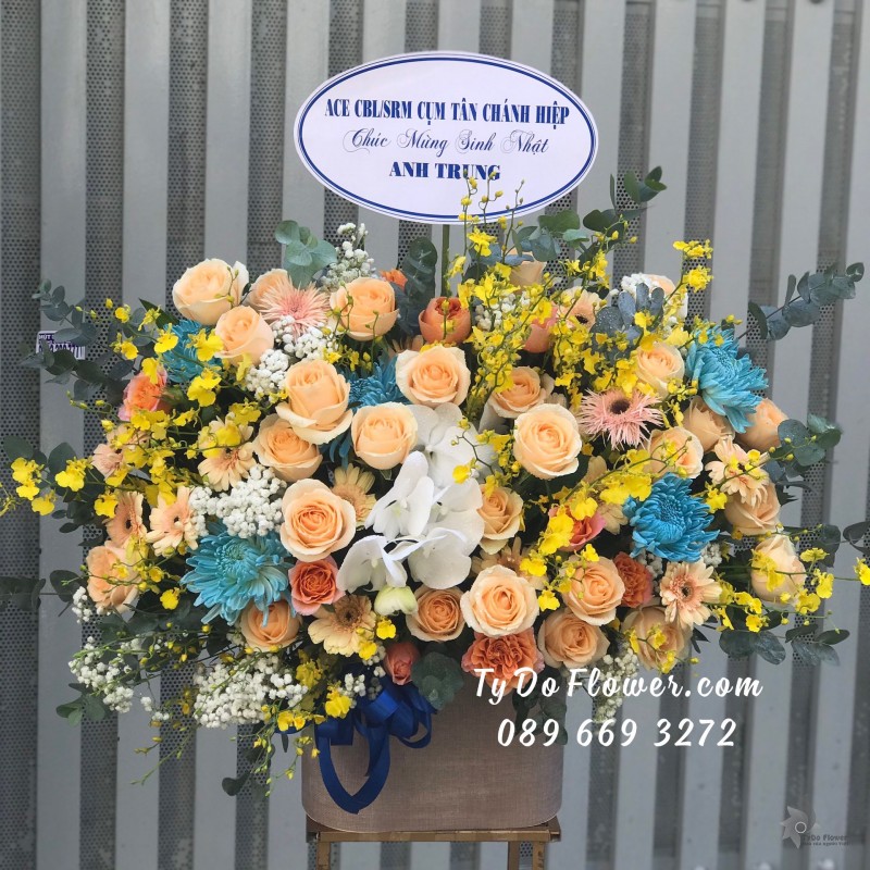 G0623803 GIỎ HOA CHÚC MỪNG SINH NHẬT thiết kế Hoa Cúc Xanh Dương, hoa hồng cam, lan vũ nữ, baby trắng, lá bạc