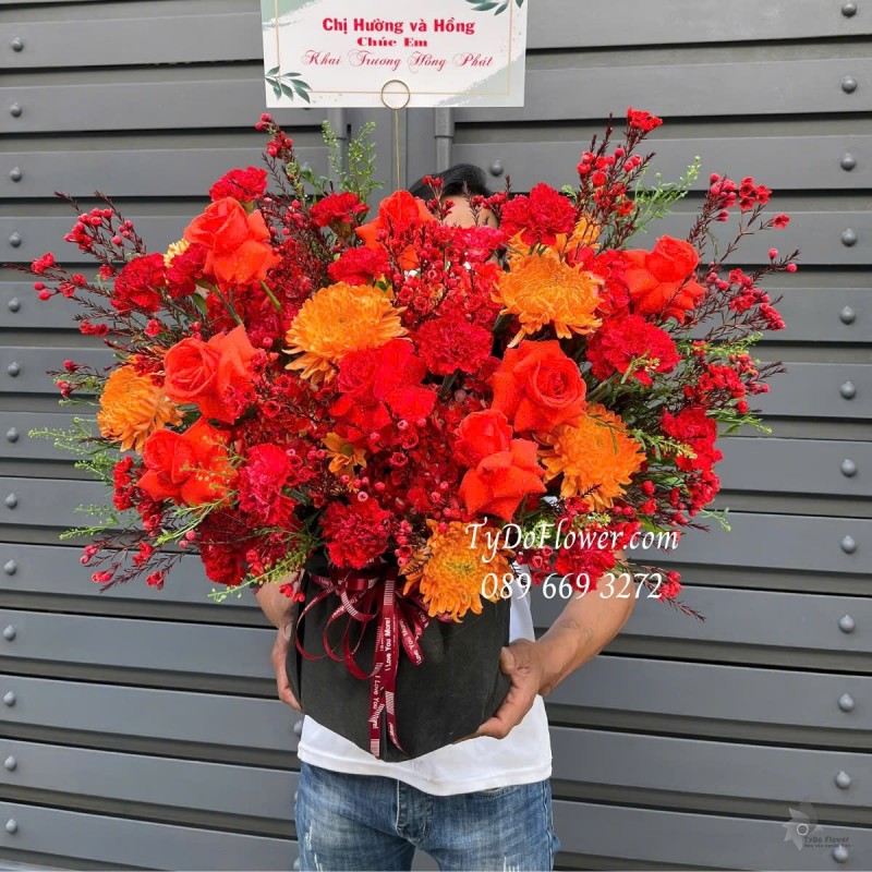 G012554 GIỎ HOA CHÚC MỪNG KHAI TRƯƠNG HỒNG PHÁT Thiết kế tông màu đỏ cam, chủ đạo Hoa Cúc, Hoa Hồng Đỏ, Hoa Thanh Liễu