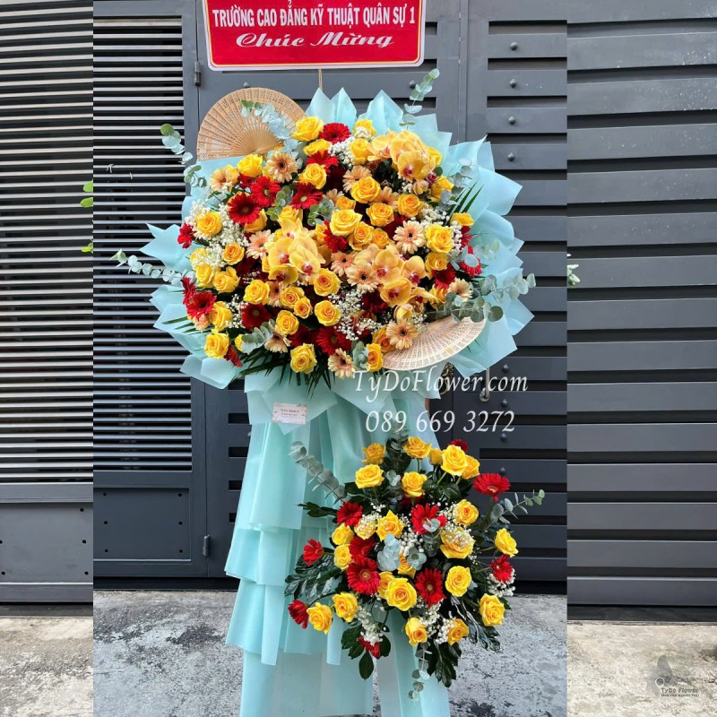 KCM0525358 KỆ HOA CHÚC MỪNG Thiết kế gam màu vàng, Hoa Hồng, Đồng Tiền, Lan Hồ Điệp