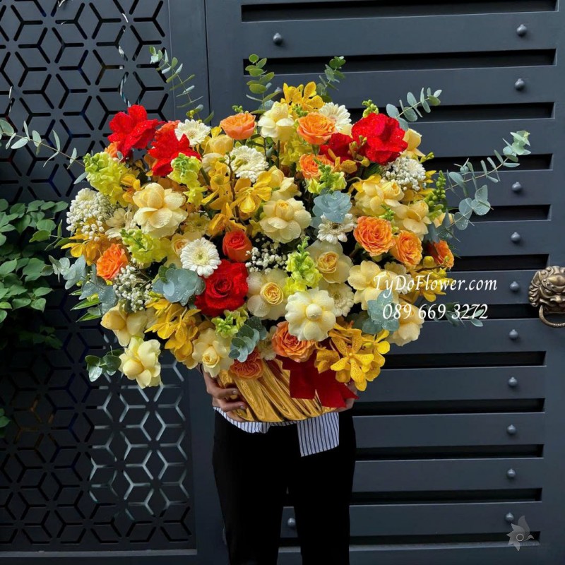 G0925684 GIỎ HOA CHÚC MỪNG Thiết kế hoa hồng vàng Victor, cam Spirit, đỏ Ecuador, lan Mokara vàng, mõm sói, đồng tiền
