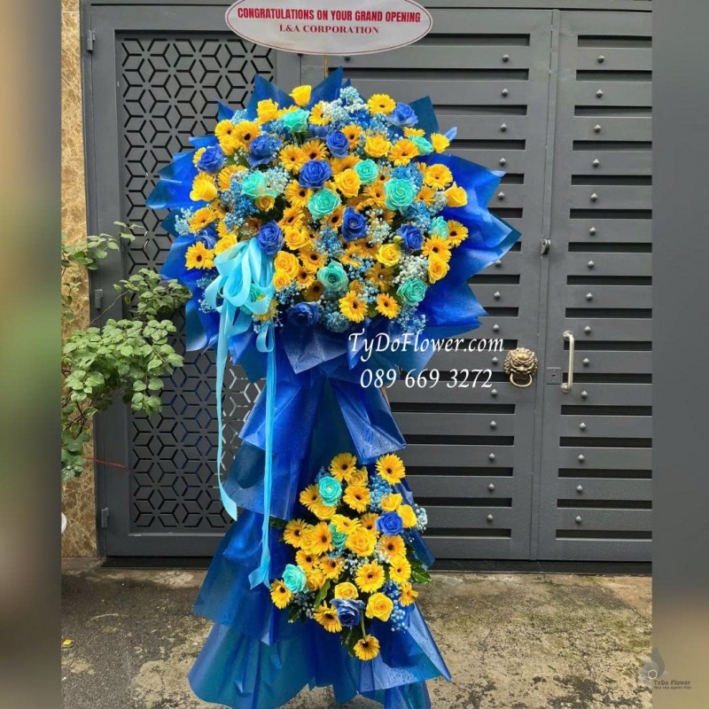 KCM0925729 KỆ HOA CHÚC MỪNG KHAI TRƯƠNG Thiết kế hoa hồng xanh dương, hoa hồng vàng Gold, đồng tiền vàng